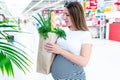 Woman supermarket grocery food bag. Pregnancy mother with healthy vegetables, fresh lettuce salad leaves in market food Royalty Free Stock Photo