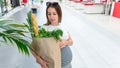 Woman supermarket grocery food bag. Pregnancy mother with healthy vegetables, fresh lettuce salad leaves in market food Royalty Free Stock Photo