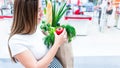 Woman supermarket grocery food bag. Pregnancy mother with healthy vegetables, fresh lettuce salad leaves in market food Royalty Free Stock Photo