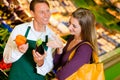 Woman in supermarket and shop assistant Royalty Free Stock Photo