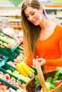 Woman in supermarket shopping groceries Royalty Free Stock Photo