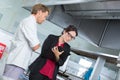 Woman supervising chefs work at kitchen Royalty Free Stock Photo