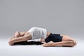 Woman in supta virasana yoga position Royalty Free Stock Photo