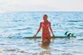 Woman surfer on beach. Pretty girl in bikini posing with surfboard in sea. Summer holidays concept. Extreme sport idea Royalty Free Stock Photo