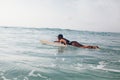 Woman surfer swimming in sea Royalty Free Stock Photo