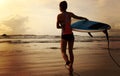 Woman surfer with white surfboard walking to the sea Royalty Free Stock Photo