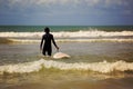 Woman surfer with white surfboard walking Royalty Free Stock Photo