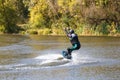 A woman surfing on wakeboard along the river Royalty Free Stock Photo