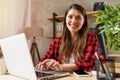 Woman surfs in internet with her laptop. She work at home as smart working