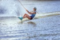 Woman surfs on the water.