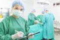 Woman Surgeons writing medical record