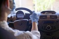 Woman in surgical face mask and gloves driving car