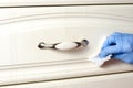 Woman with surgical gloves wiping furniture handles with disinfectant wipes . Prevent the spread of bacteria and the covid-19