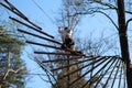 Woman surmountain obstacles in the rope park