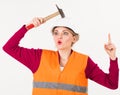 Woman with surprised face knocks with hammer on head