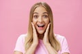 Woman surprised to see own face without imperfactions treating acne feeling beautiful and happy touching cheeks, smiling Royalty Free Stock Photo
