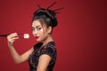 Asian woman eating sushi and rolls on a red background. 8 - Eight March, Black Friday, Setsubun Japanese Festival, sushi