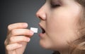 Woman is swallowing cube of sugar. Unhealthy eating concept Royalty Free Stock Photo