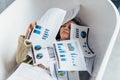 Woman is swamped with work, with a lot of paper, documents piled on top of her. She is lying in the tub Royalty Free Stock Photo