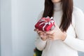 Woman in sweater holding red small gift box Royalty Free Stock Photo