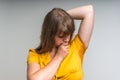 Woman with sweating under armpit in yellow dress