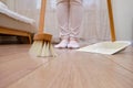 Woman sweeping floor with broom and dustpan while cleaning home living room Royalty Free Stock Photo