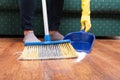 Woman sweeping floor with broom and dustpan Royalty Free Stock Photo
