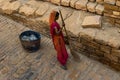 Woman sweeping the streets of Golden Fort with a broomstick