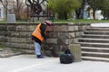 A woman sweeps the street cleaner