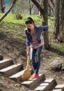 Woman sweeps with a sweeper