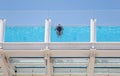 A woman swim in the rooftop swimming pool of her hotel in Magaluf in Mallorca