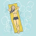 Woman swim on on the yellow air mattress in pool.
