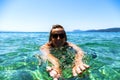 Woman swiming in the sea on tropical island, smiling at camera w Royalty Free Stock Photo