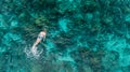 Woman swimming in blue sea. Snorkeling girl in full-face snorkeling mask. Coral reef in shallow sea. Snorkel undersea. Seashore Royalty Free Stock Photo