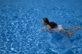 Woman swimming breaststroke in a pool Royalty Free Stock Photo