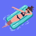 Woman swimming, floating in water pool, lying and relaxing on inflatable rubber mattress. Young girl in bikini Royalty Free Stock Photo