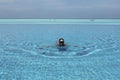 Woman swimming in infinity pool in Maldives Royalty Free Stock Photo