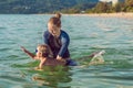 Woman swimming instructor for children is teaching a happy boy t