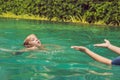 Woman swimming instructor for children is teaching a happy boy to swim in the pool Royalty Free Stock Photo