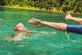 Woman swimming instructor for children is teaching a happy boy to swim in the pool Royalty Free Stock Photo