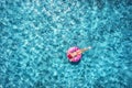 Woman swimming on pink donut swim ring in blue sea. Aerial view Royalty Free Stock Photo