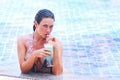 Woman in swimming pool with cocktail Royalty Free Stock Photo