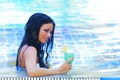 Woman in swimming pool with cocktail Royalty Free Stock Photo