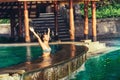 Woman in swimming pool, swimming and sunbathing on a sunrise golden light