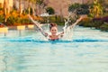 Woman in swimming pool with water splashes