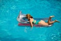 Woman in swimmsuit on summer vacation. Girl swimming pool. Summer lady on inflatable mattress. Royalty Free Stock Photo