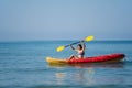 Woman in swimsuit paddling a kayak boat in sea Royalty Free Stock Photo