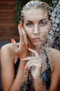 Woman In Swimsuit Showering Under Water, Washing Hair, Cleaning Body Outdoors At Luxury Spa Resort In Summer. fashion model Royalty Free Stock Photo