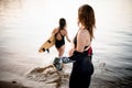 Woman in swimsuit with surf in her hand goes into the water