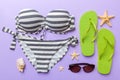 Woman swimwear and beach accessories flat lay top view on colored background Summer travel concept. bikini swimsuit Royalty Free Stock Photo